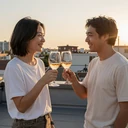 Couple toasting with wine glasses on a rooftop at sunset